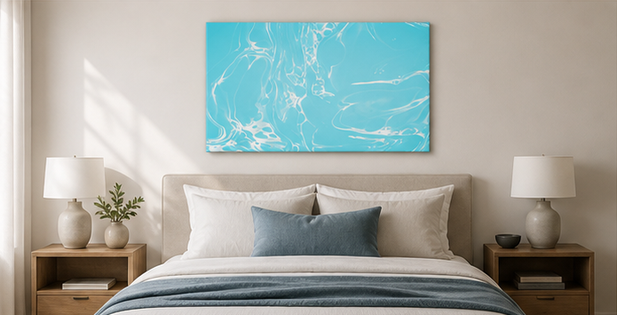 Blue abstract painting on a wall above a beige sofa with decorative elements.